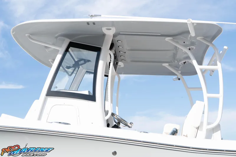 Slide: The Image of 2026 Sea Hunt Gamefish 30 Coffin Box boat with T-top and console, under clear sky. - 28