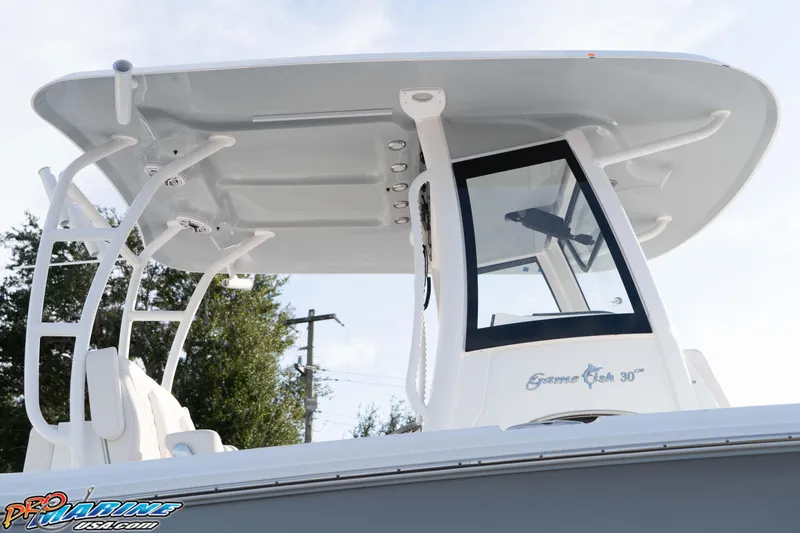 Slide: The Image of 2026 Sea Hunt Gamefish 30 Coffin Box boat with T-top and console, side view. - 30