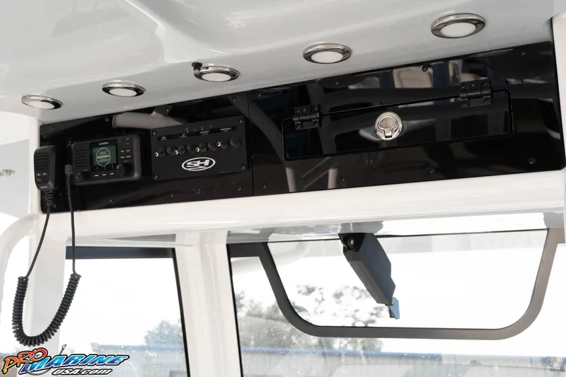 Slide: The Image of 2026 Sea Hunt Gamefish 30 Coffin Box boat console with Garmin electronics and storage compartment. - 37