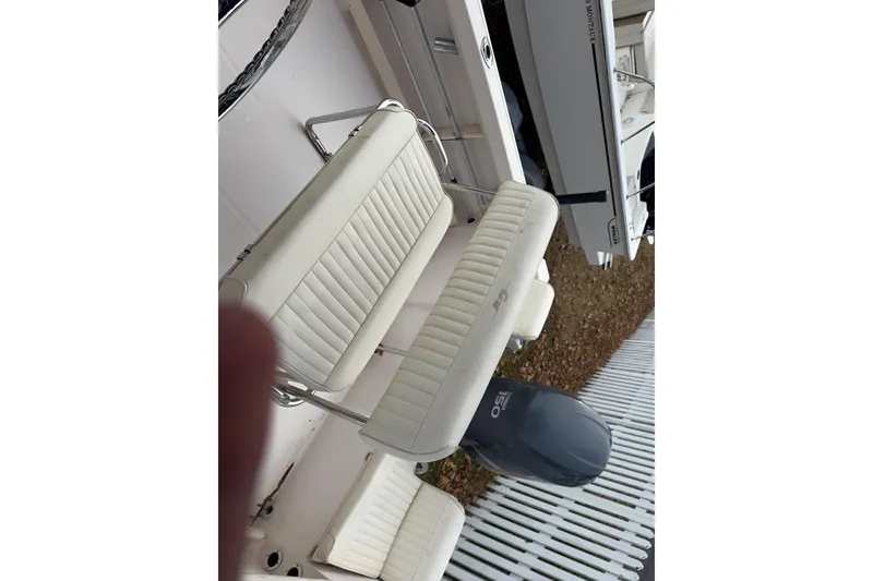 Slide: The Image of 2008 Grady White 180 Sportsman boat with white cushioned seating and outboard motor. - 5