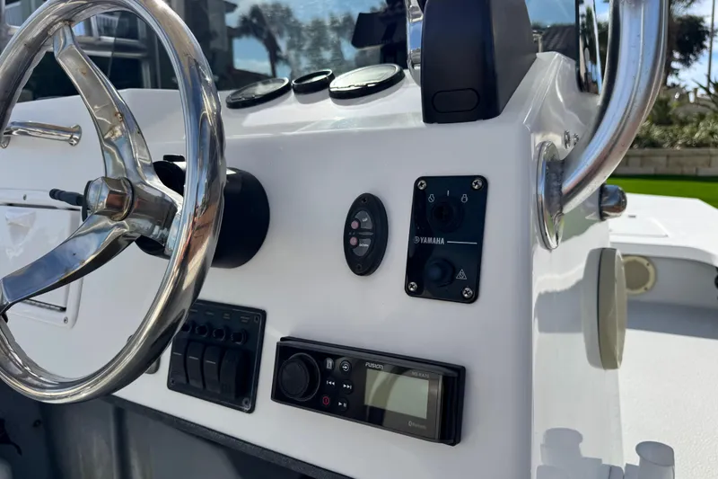 Slide: The Image of Close-up of 2012 Majek Illusion 226 boat dashboard with steering wheel and controls. - 10