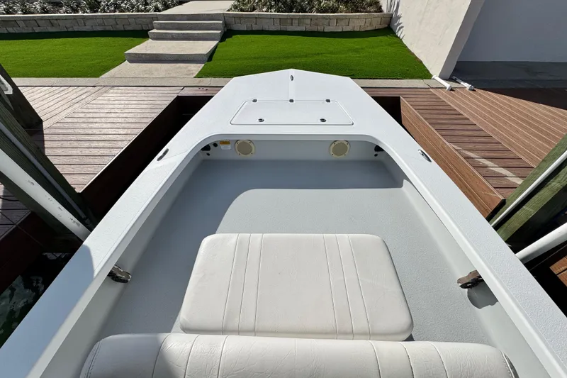 Slide: The Image of 2012 Majek Illusion 226 boat interior with white seating and deck view. - 16