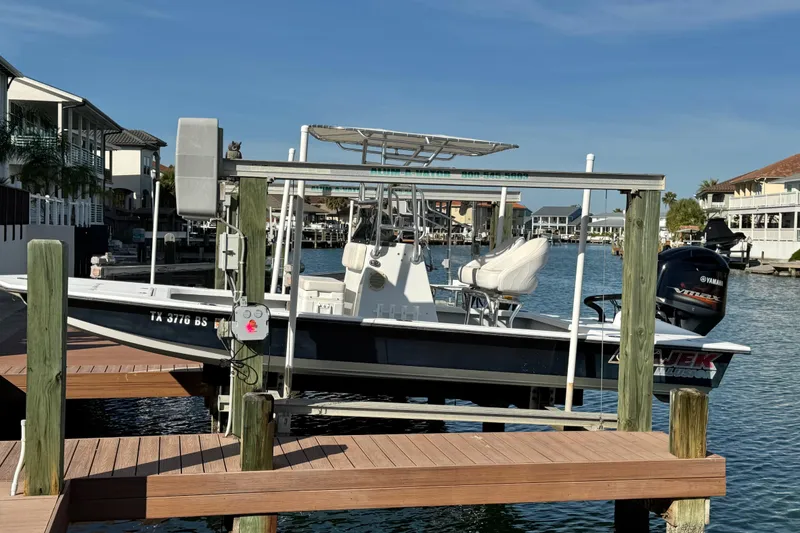 Slide: The Image of 2012 Majek Illusion 226 boat docked in a scenic waterfront setting. - 0