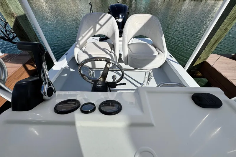Slide: The Image of 2012 Majek Illusion 226 boat interior with steering wheel and dual seats. - 12