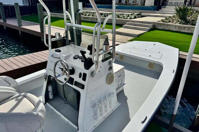 Slide: The Image of 2012 Majek Illusion 226 boat with steering console, docked by a wooden pier. - 3