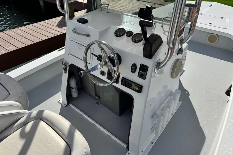 Slide: The Image of 2012 Majek Illusion 226 boat console with steering wheel and controls. - 9