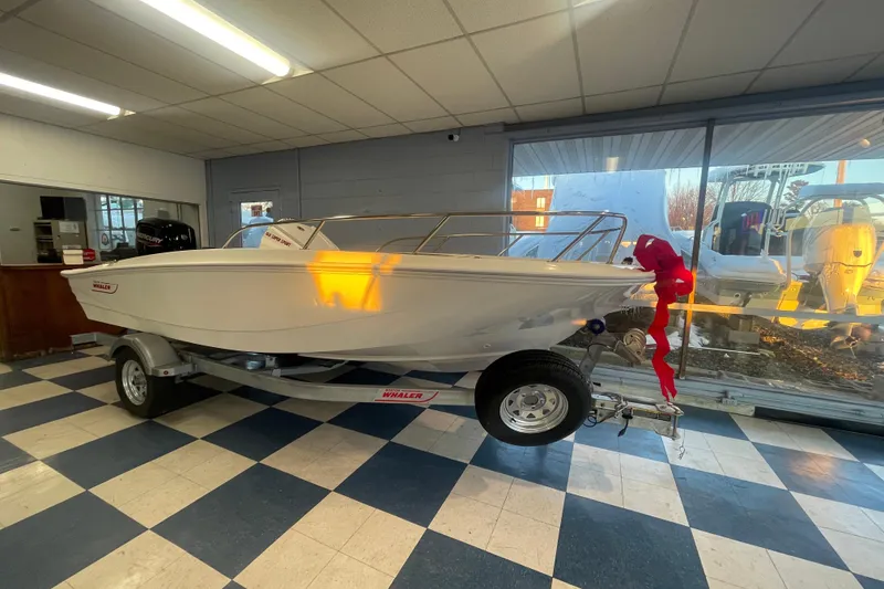 Slide: The Image of 2026 Boston Whaler 160 Super Sport in showroom with red bow. - 2