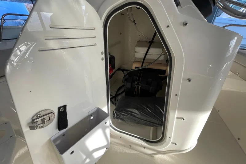 Slide: The Image of Interior of 2026 Boston Whaler 150 Montauk with storage compartment. - 13
