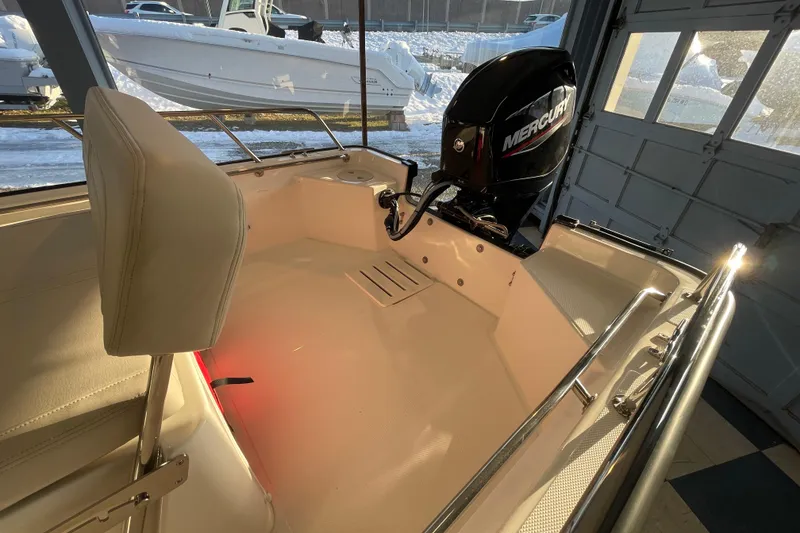 Slide: The Image of Interior of a 2026 Boston Whaler 150 Montauk boat with Mercury engine. - 15