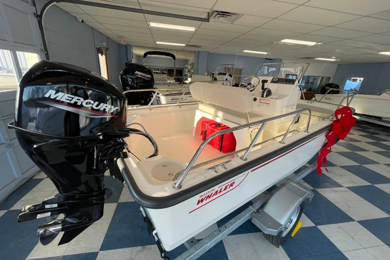 Slide: The Image of 2026 Boston Whaler 150 Montauk boat in showroom. - 4