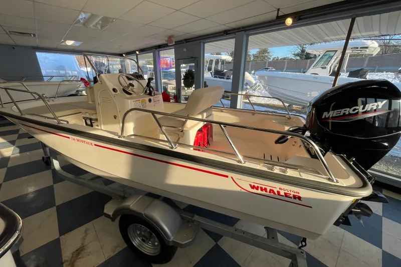 Slide: The Image of 2026 Boston Whaler 150 Montauk boat in showroom. - 5
