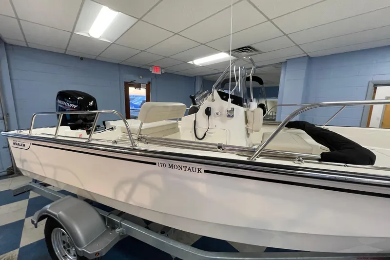 Slide: The Image of 2026 Boston Whaler 170 Montauk boat in showroom. - 3