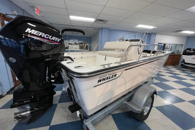Slide: The Image of Boston Whaler 170 Montauk 2026 with Mercury engine in showroom. - 4