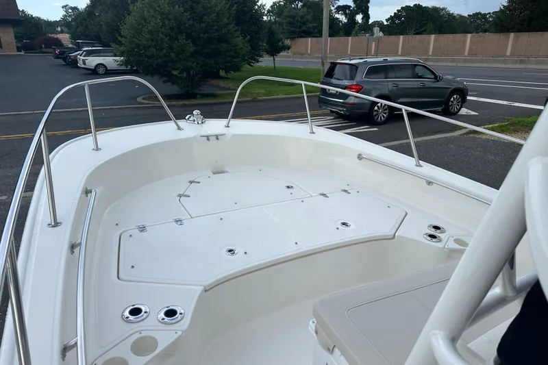 Slide: The Image of Boston Whaler 210 Montauk 2025 boat, front deck view, parked in lot. - 4