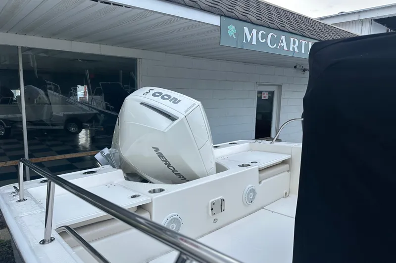 Slide: The Image of Boston Whaler 210 Montauk 2025 with Mercury engine outside a store. - 6