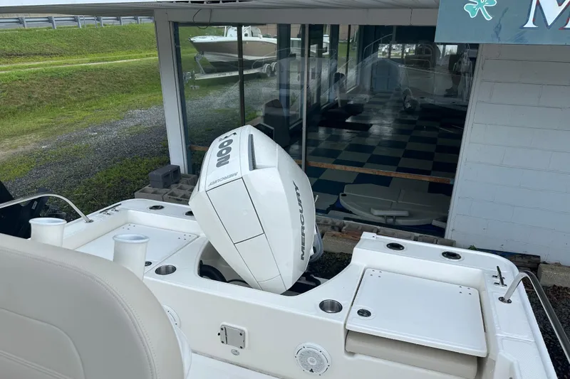 Slide: The Image of Boston Whaler 210 Montauk 2025 with Mercury engine, parked outdoors. - 7