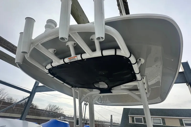 Slide: The Image of Boston Whaler 220 Dauntless 2025, T-top view with rod holders. - 15