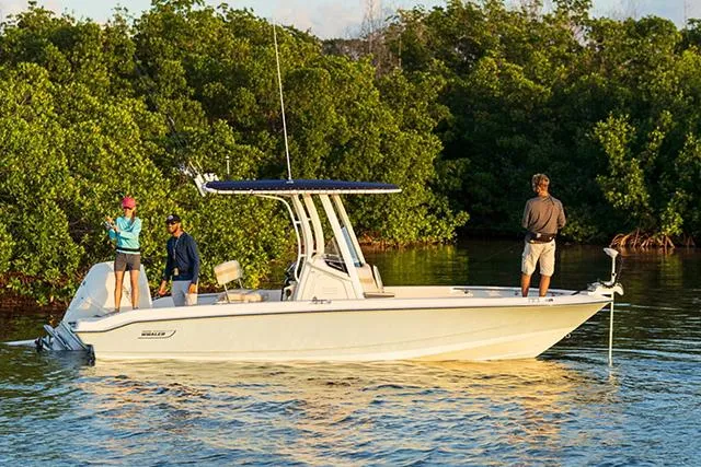 Slide: The Image of Manufacturer Provided Image: 2026 Boston Whaler 220 Dauntless boat with people fishing near lush greenery. - 20