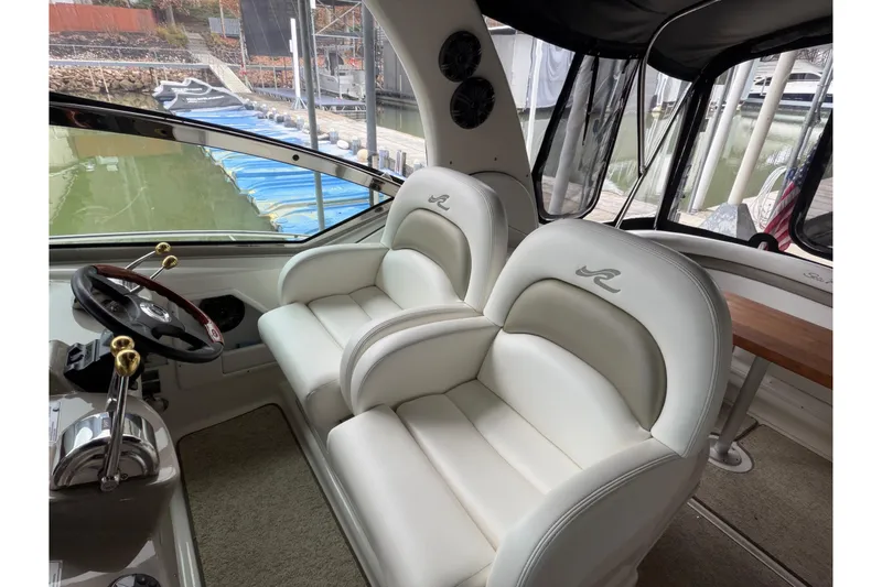 Slide: The Image of 2007 Sea Ray 340 Sundancer cockpit with luxurious white leather seats and steering wheel. - 10