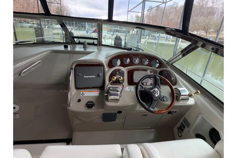 Slide: The Image of 2007 Sea Ray 340 Sundancer helm with steering wheel and navigation controls. - 11
