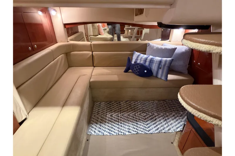Slide: The Image of Interior of 2007 Sea Ray 340 Sundancer with beige seating and nautical-themed pillows. - 17