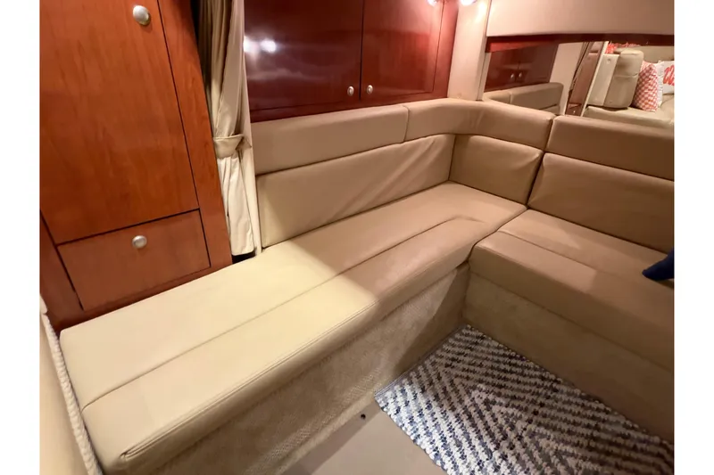 Slide: The Image of Luxurious interior of 2007 Sea Ray 340 Sundancer with beige seating and wooden cabinetry. - 18