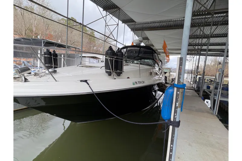 Slide: The Image of 2007 Sea Ray 340 Sundancer docked under a covered marina. - 3