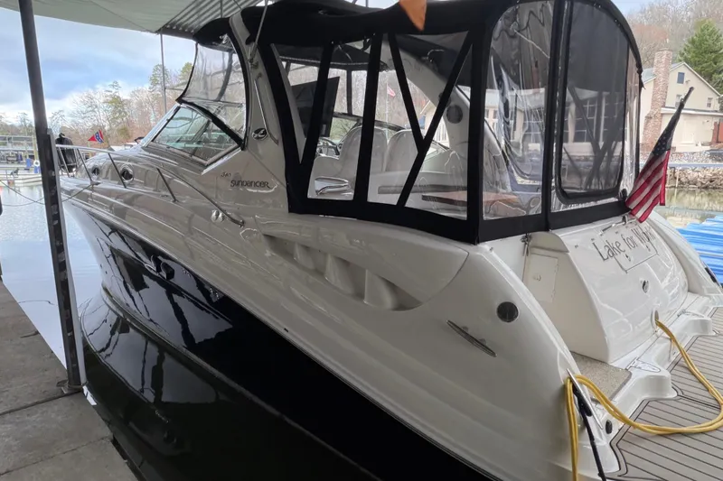 Slide: The Image of 2007 Sea Ray 340 Sundancer docked, featuring sleek design and covered cockpit. - 4