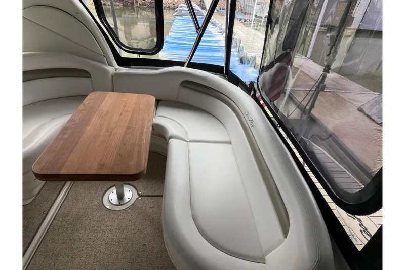 Slide: The Image of Interior of 2007 Sea Ray 340 Sundancer with curved seating and wooden table. - 5