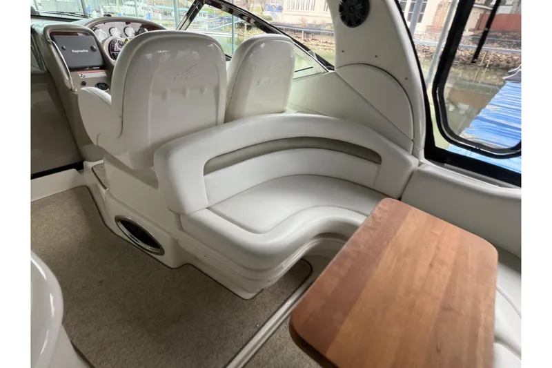 Slide: The Image of 2007 Sea Ray 340 Sundancer interior with white seating and wooden table. - 6