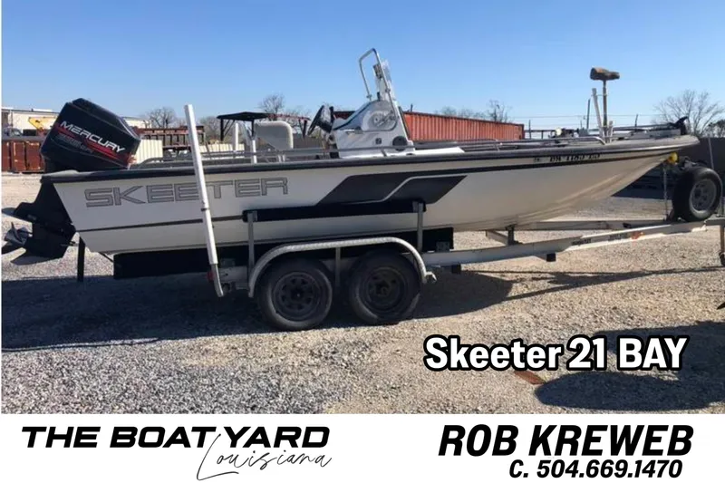 Slide: The Image of 1996 Skeeter ZX22 Bay boat on trailer, featuring Mercury outboard motor. - 13