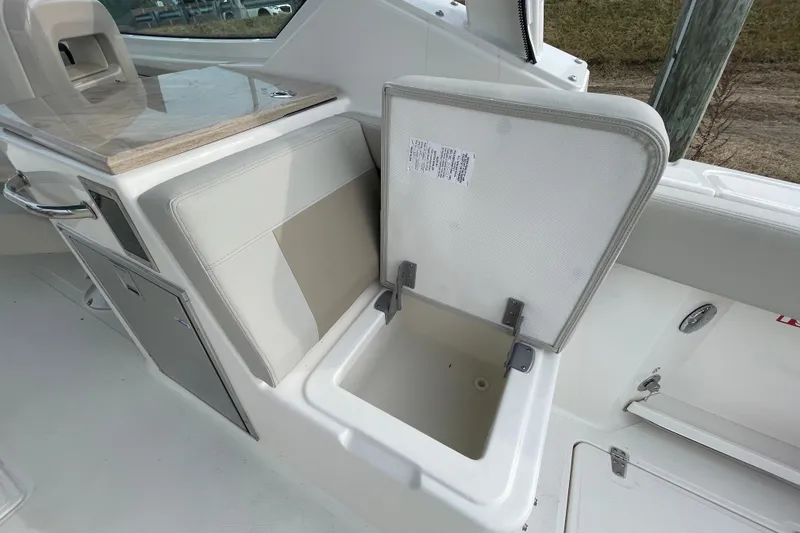 Slide: The Image of Boston Whaler 280 Vantage 2026, open storage compartment on boat. - 25
