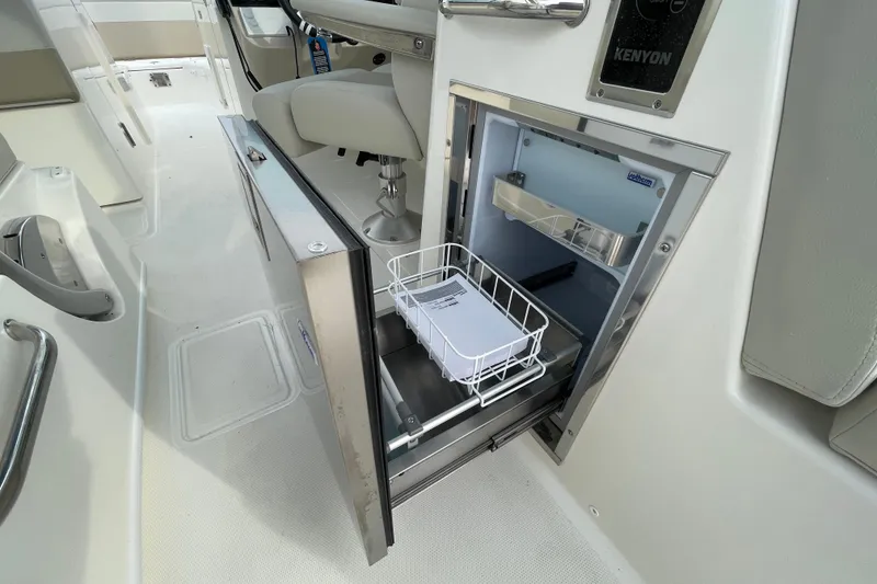 Slide: The Image of Boston Whaler 280 Vantage 2026 with open refrigerator. - 26