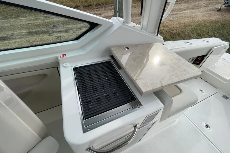Slide: The Image of Boston Whaler 280 Vantage 2026 with grill and foldable table. - 27