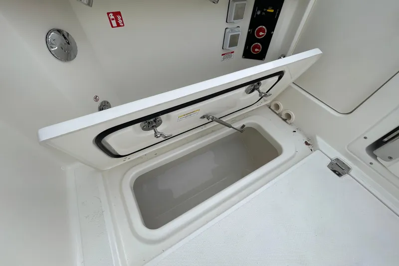 Slide: The Image of Boston Whaler 280 Vantage 2026 storage compartment with open hatch. - 31