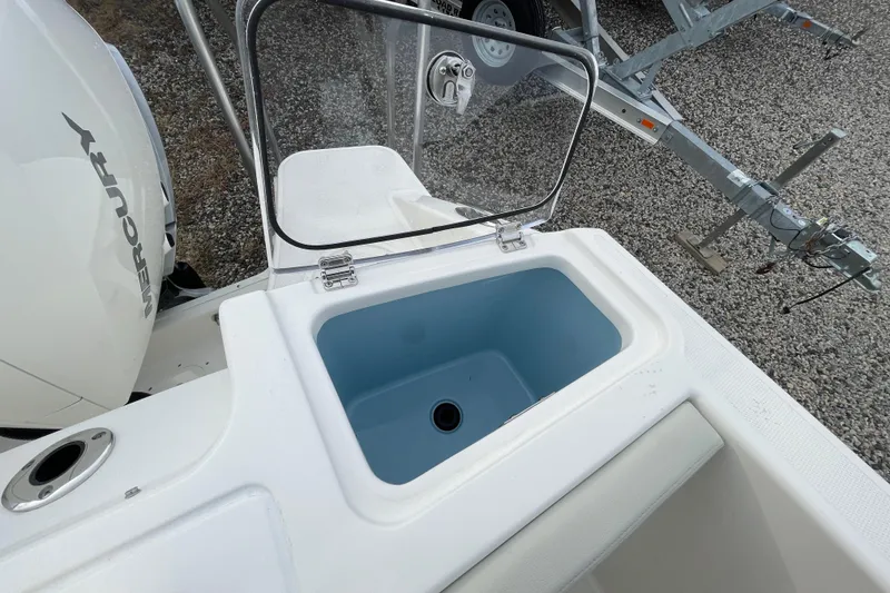 Slide: The Image of Boston Whaler 280 Vantage 2026 with open storage compartment and Mercury engine. - 36
