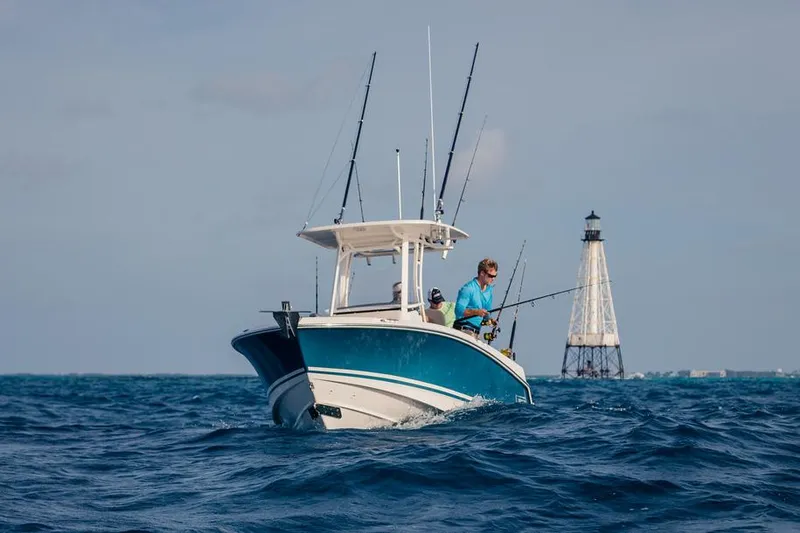 Slide: The Image of 2026 Boston Whaler 230 Outrage with Mercury engine, side view. - 3