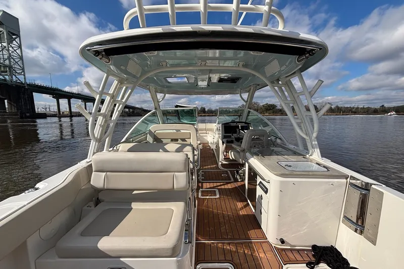 Slide: The Image of 2021 Boston Whaler 320 Vantage boat interior with seating and helm, on a sunny day. - 18