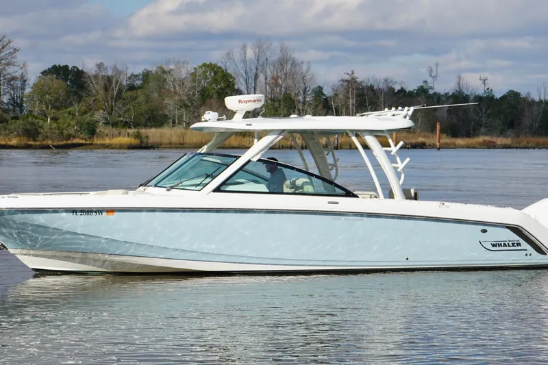 Slide: The Image of 2021 Boston Whaler 320 Vantage boat cruising on a calm river. - 3