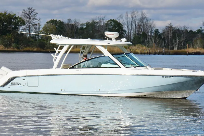 Slide: The Image of 2021 Boston Whaler 320 Vantage boat on calm water, side view. - 4