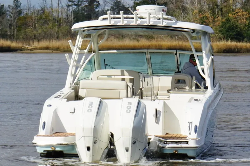 Slide: The Image of 2021 Boston Whaler 320 Vantage boat cruising on a calm river. - 5