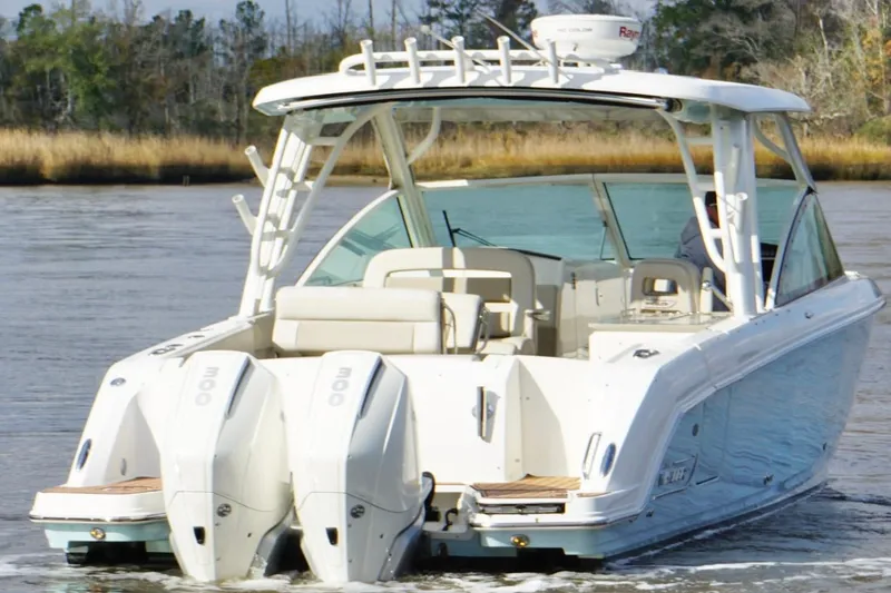 Slide: The Image of 2021 Boston Whaler 320 Vantage boat cruising on a calm river. - 7