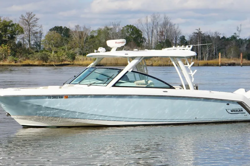 Slide: The Image of 2021 Boston Whaler 320 Vantage boat on calm water, side view. - 9