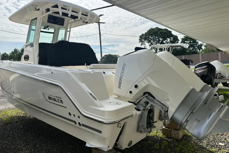 Slide: The Image of 2025 Boston Whaler 250 Outrage with Mercury engine, side view. - 2