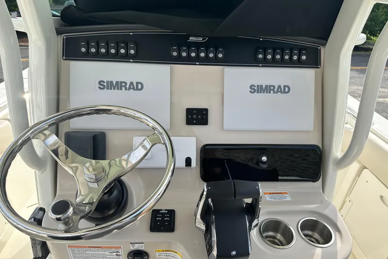 Slide: The Image of Boston Whaler 250 Outrage 2025 helm with Simrad displays. - 6