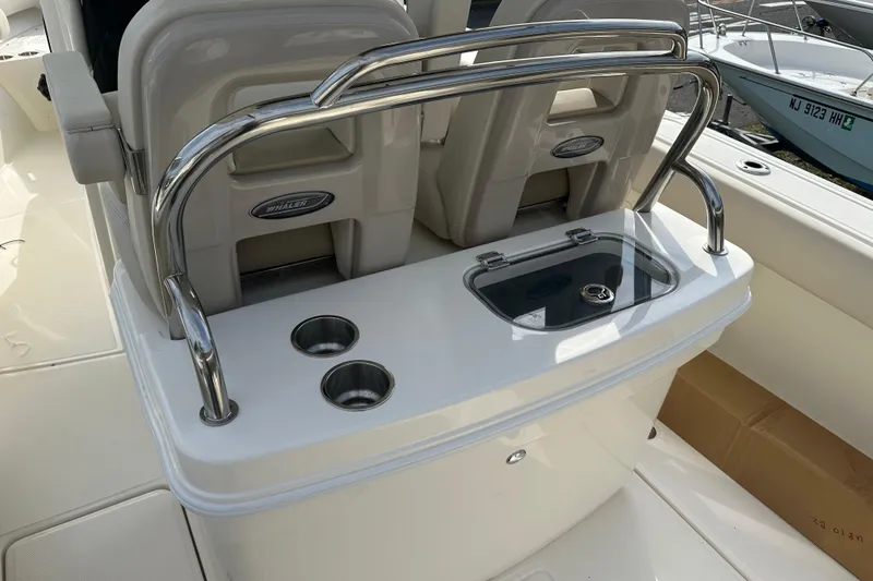 Slide: The Image of Boston Whaler 250 Outrage 2025, seating area with stainless steel railing. - 9