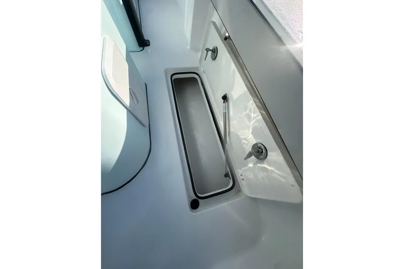 Slide: The Image of 2026 Delta Boatworks Delta D245 interior storage compartment with open hatch and hydraulic support. - 22