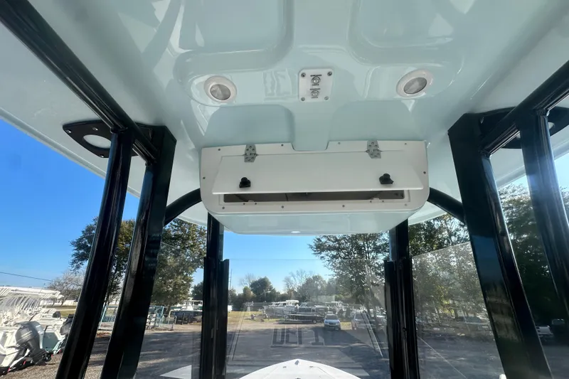 Slide: The Image of Interior view of 2026 Delta Boatworks Delta D245 with overhead storage and windows. - 29