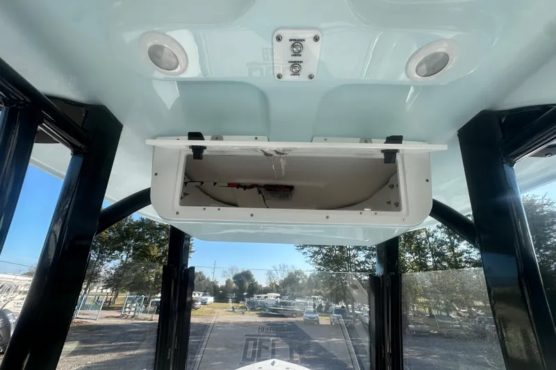Slide: The Image of 2026 Delta Boatworks Delta D245 interior with open storage compartment and lighting controls. - 30