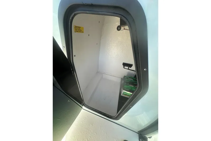 Slide: The Image of 2026 Delta Boatworks Delta D245 storage compartment with visible battery and equipment. - 37